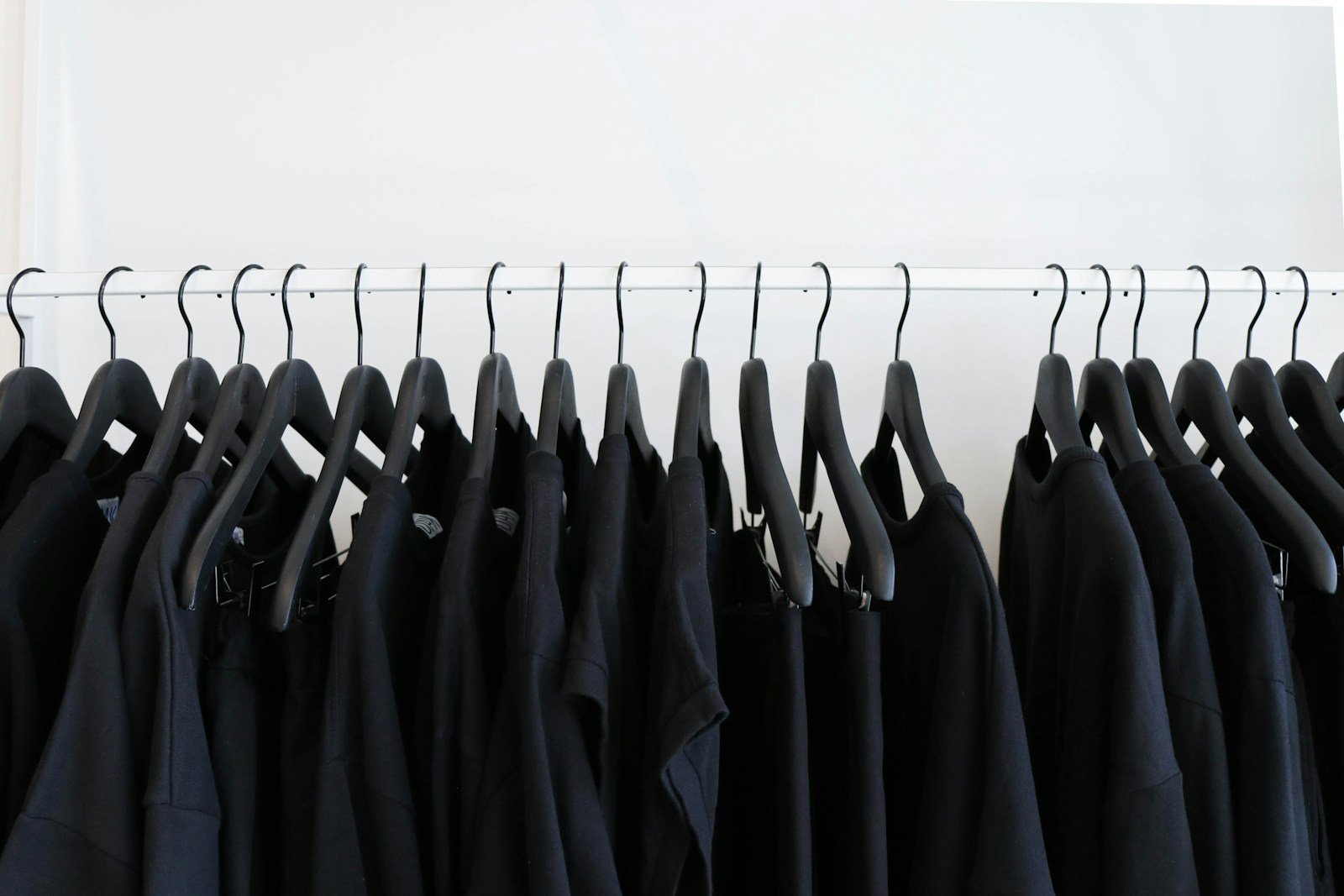 Confección de Ropa D.L CONFECCION black clothes hanged in rack